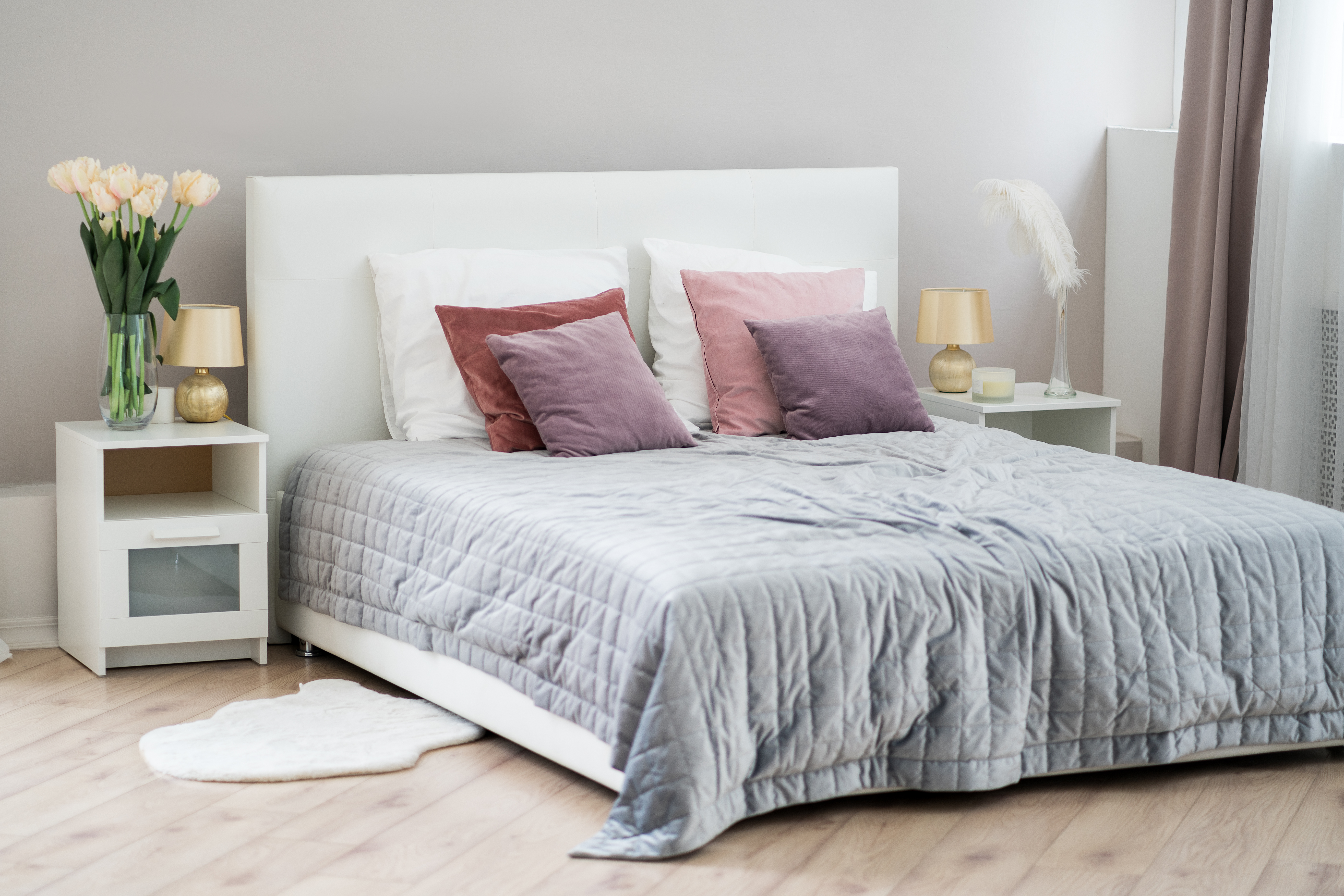 Low-profile bed with a gray comforter 
