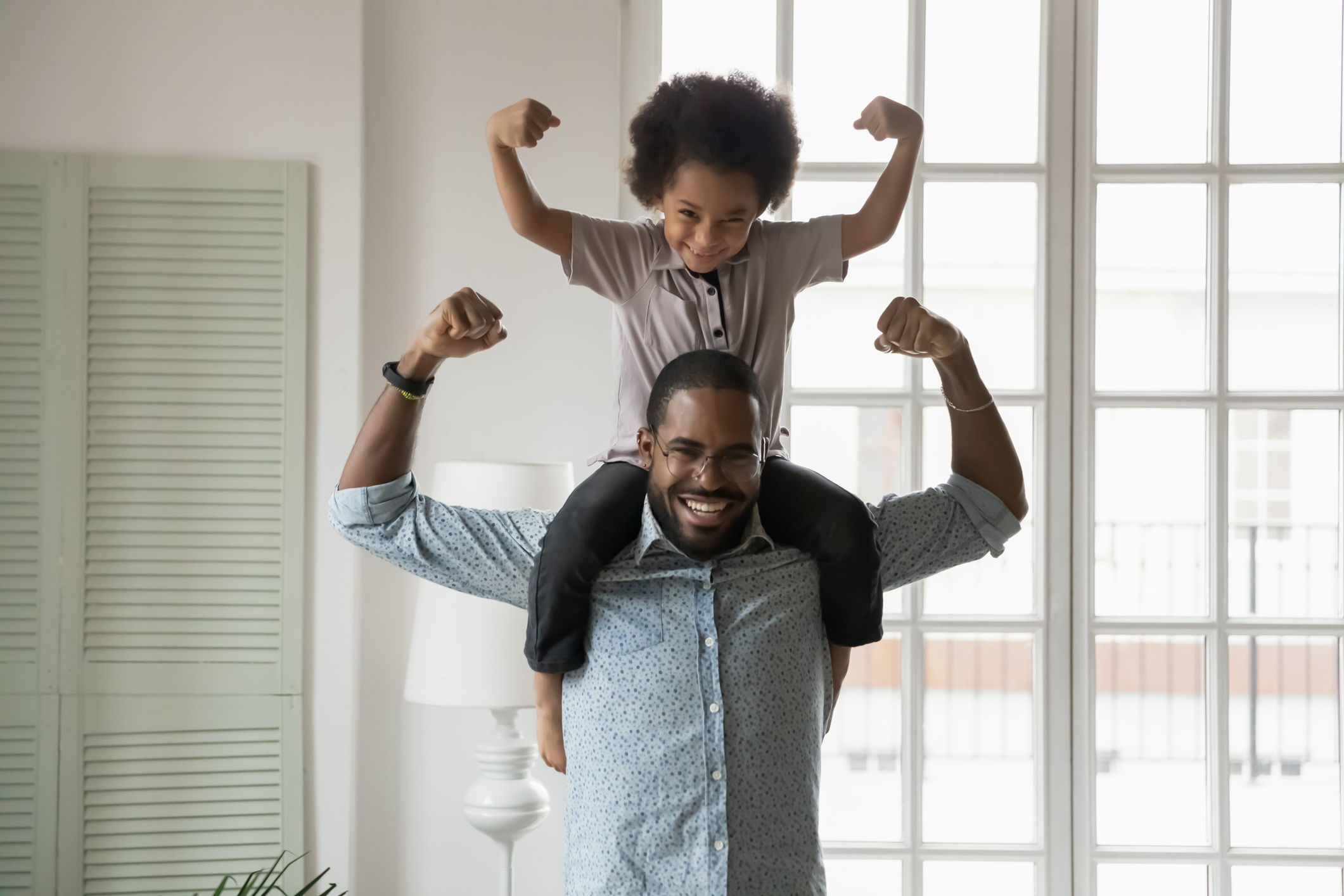 father and son flexing their muscles