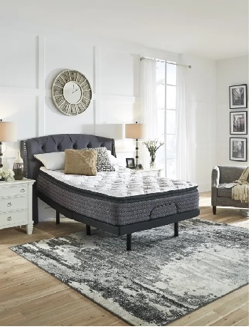 The Sierra Sleep by Ashley M627 collection pillow top mattress on an adjustable bed base with décor 