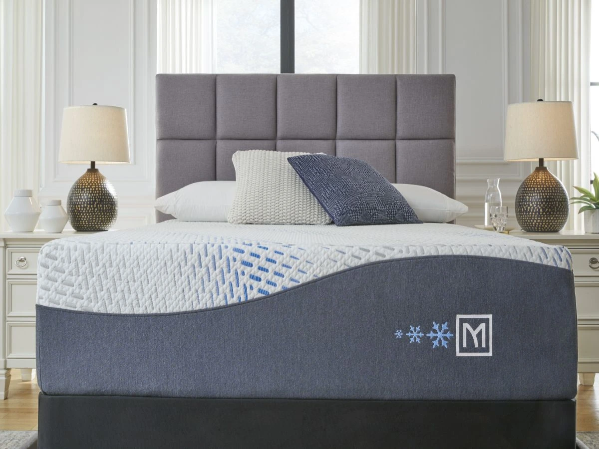 The Sierra Sleep by Ashley Millennium collection hybrid mattress in a bedroom with décor 