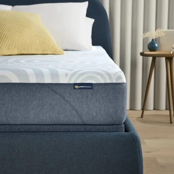 The Serta Perfect Sleeper Nestled Night mattress with a platform and décor 