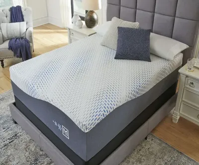 The Sierra Sleep by Ashley Millennium collection mattress with bedding and décor 