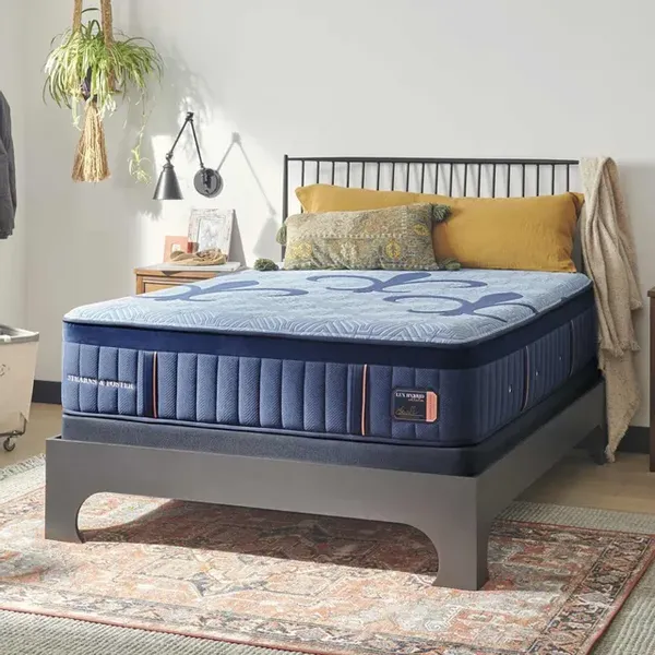 The Stearns & Foster Lux Hybrid mattress with bedding and décor 