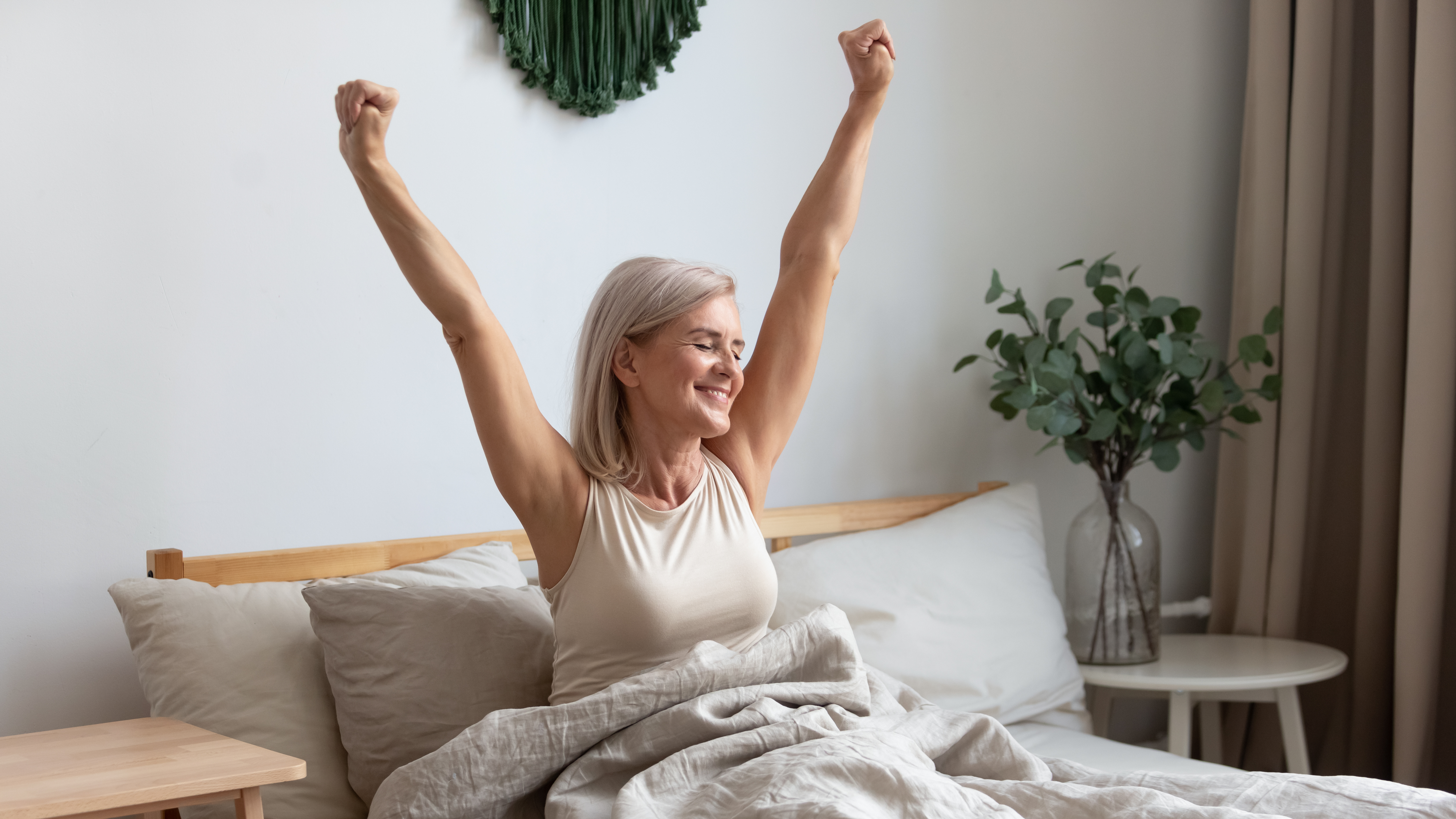 woman waking up refreshed in bed