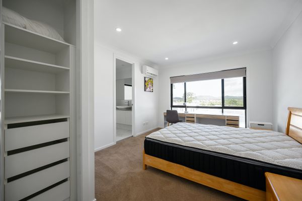 An unmade bed or mattress in an empty bedroom