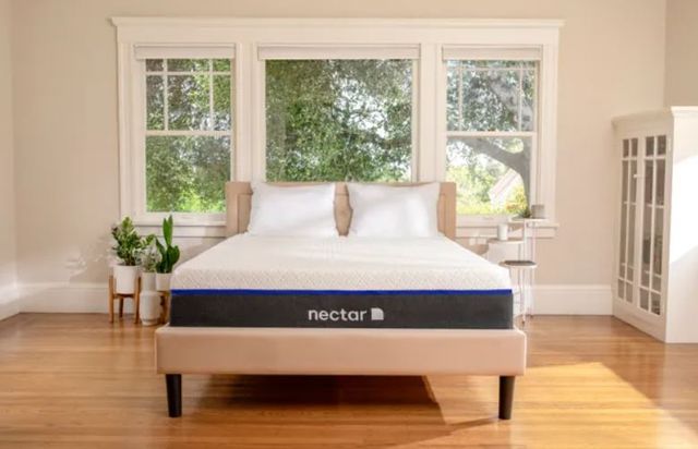 front view of a minimalist beige bedroom with a nectar mattress on a beige bed frame.