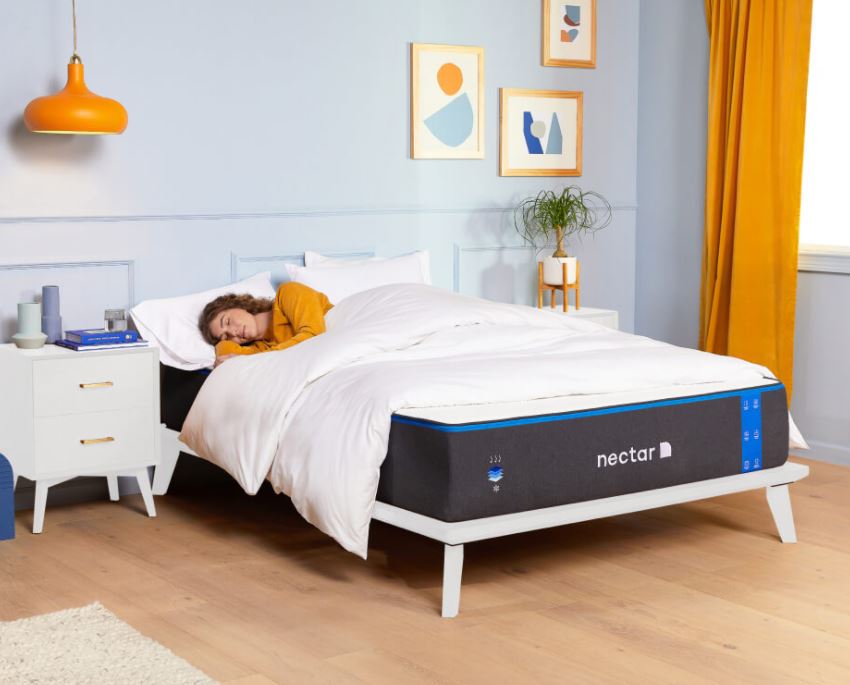 A woman sleeps atop her Nectar mattress in a whimsical bedroom
