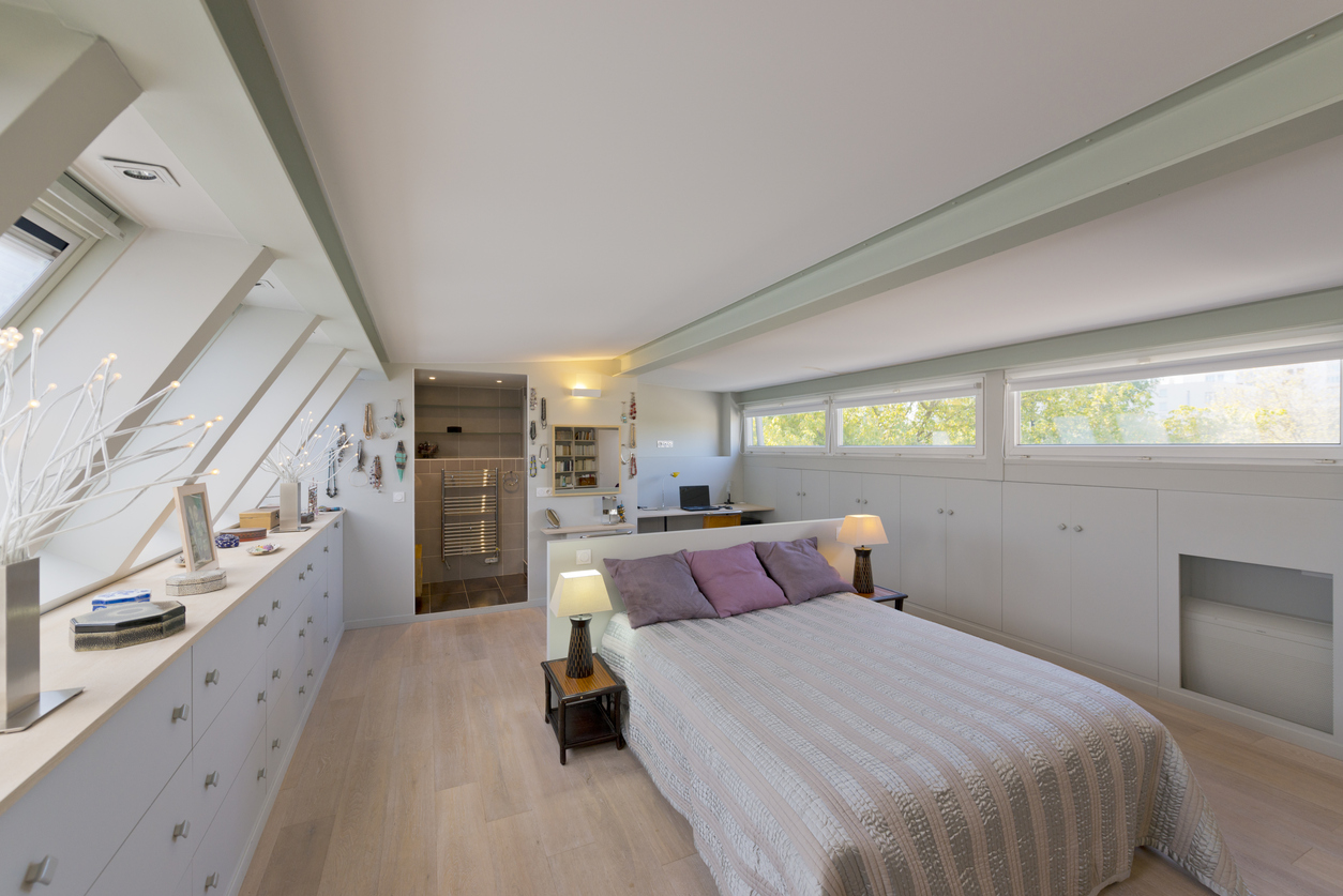 a queen bed in a loft bedroom