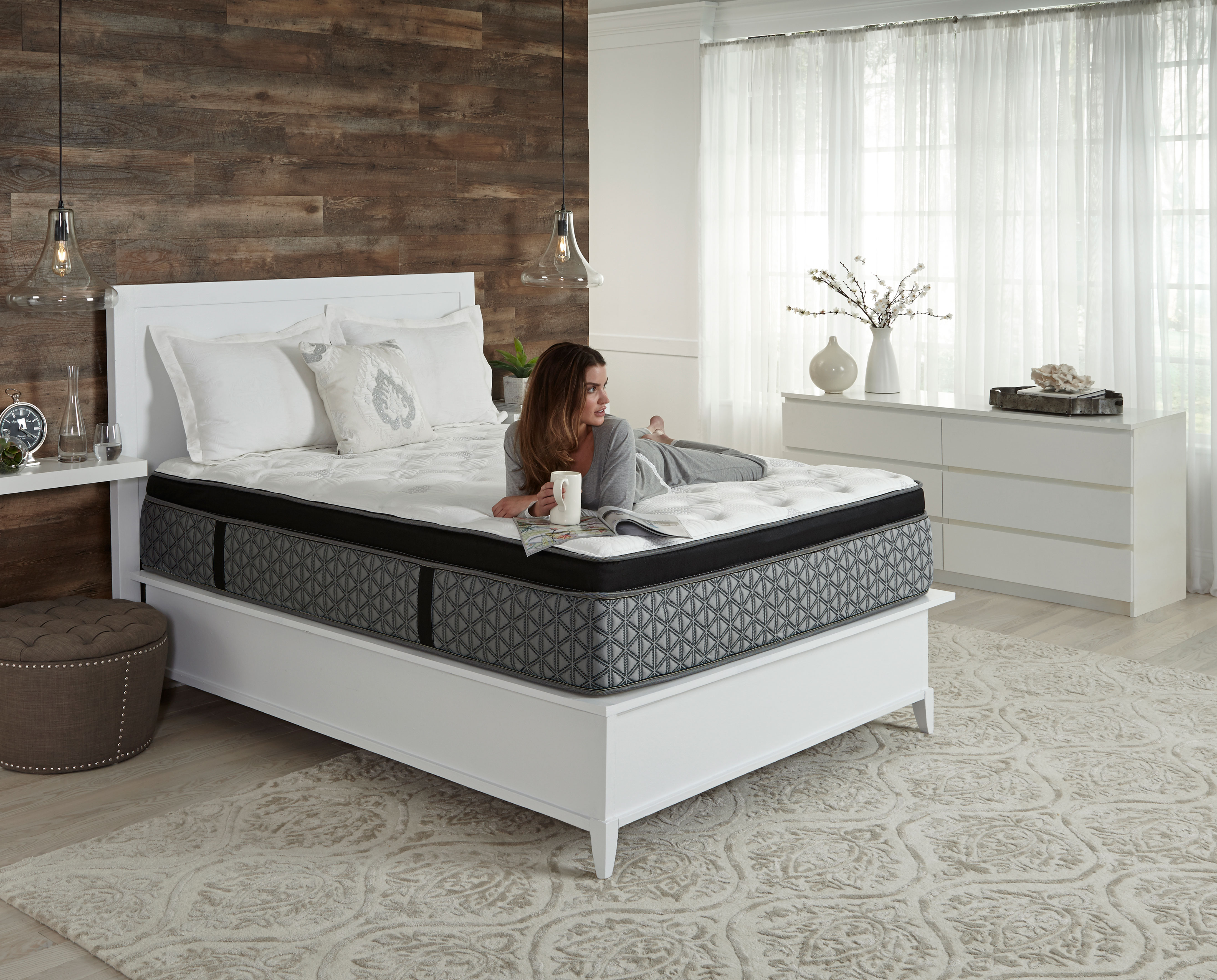 woman lounges on Scott Living Comfort Care mattress with coffee mug in hand