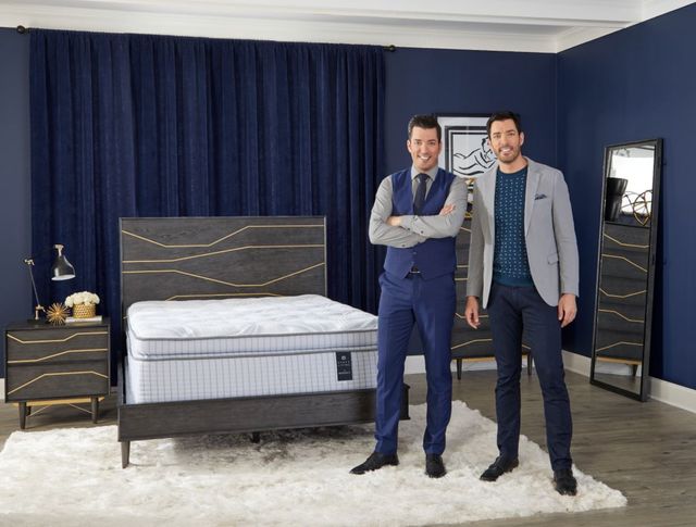 front view of Drew and Jonathan Scott in front of a scott living by Restonic mattress