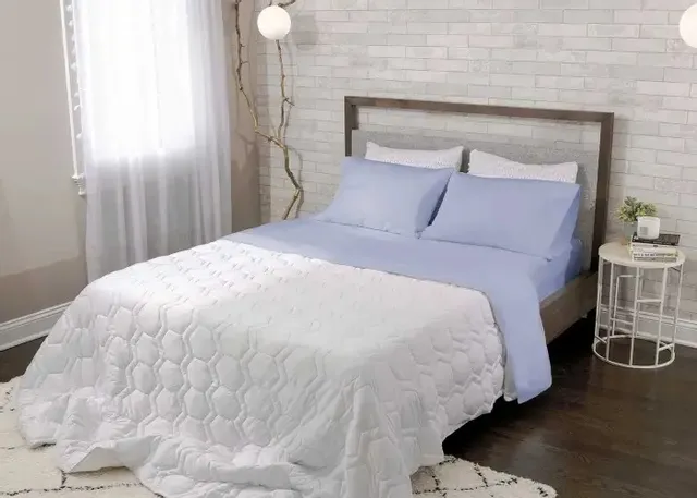The Bedgear basic mist queen-size bedding set on a mattress 
