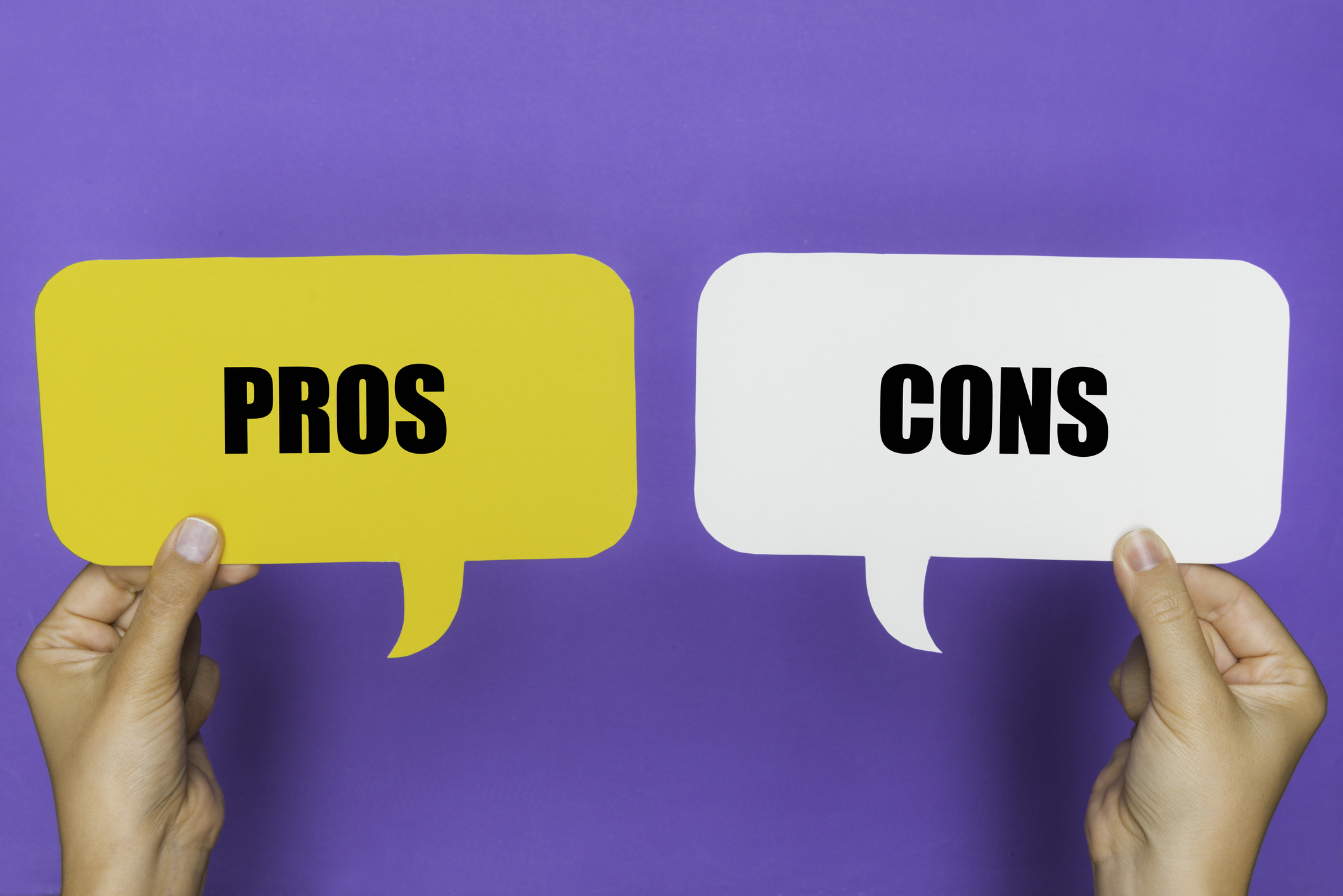 A white and yellow pros and cons paper conversation bubble on a purple background 