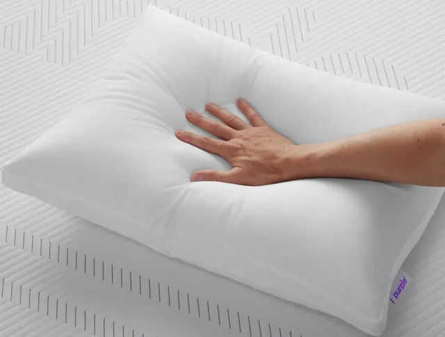 A person pressing on a Purple Cloud collection bed pillow 