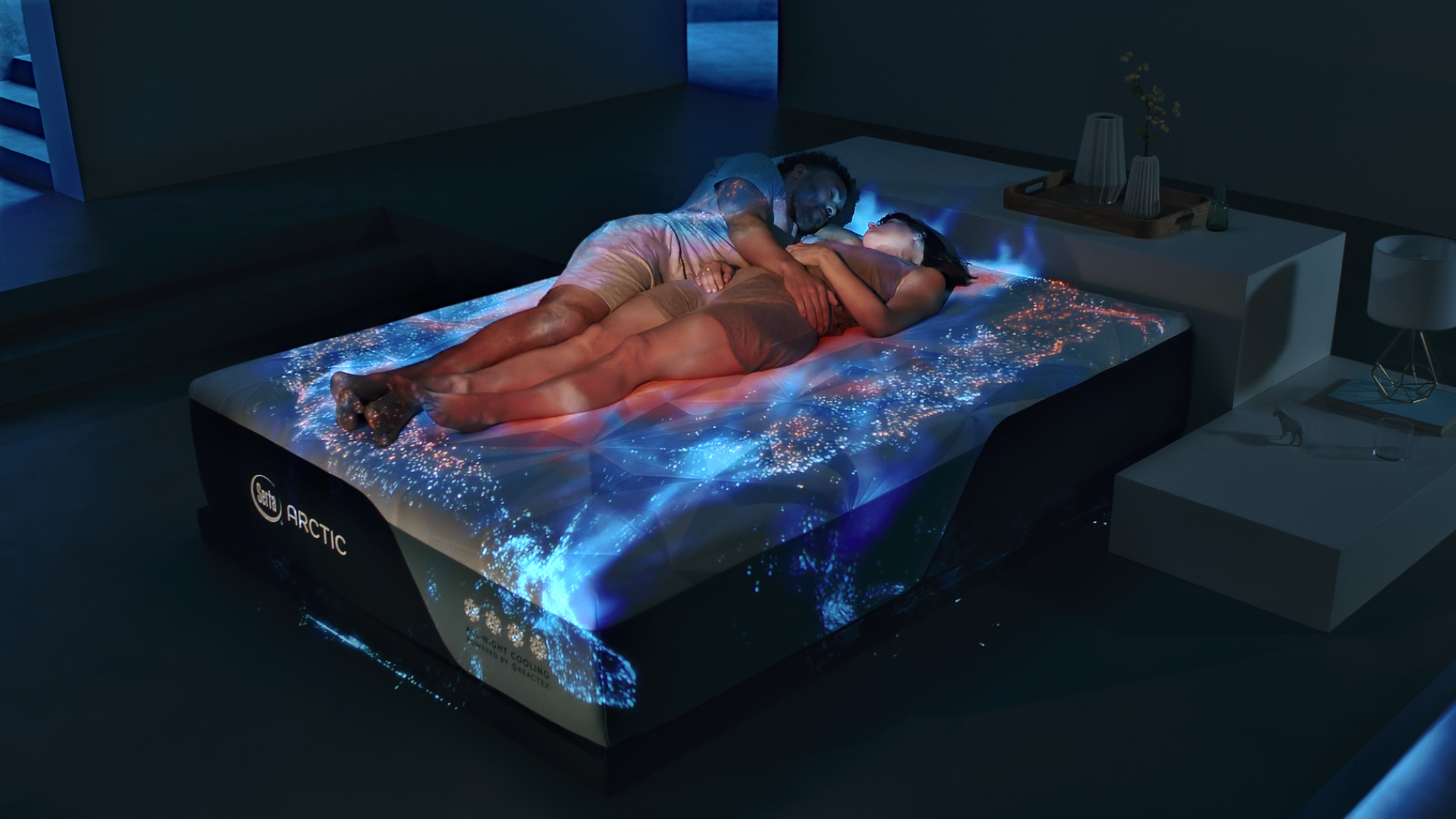 A couple sleeping on a Serta Arctic mattress with light depictions of cool areas 