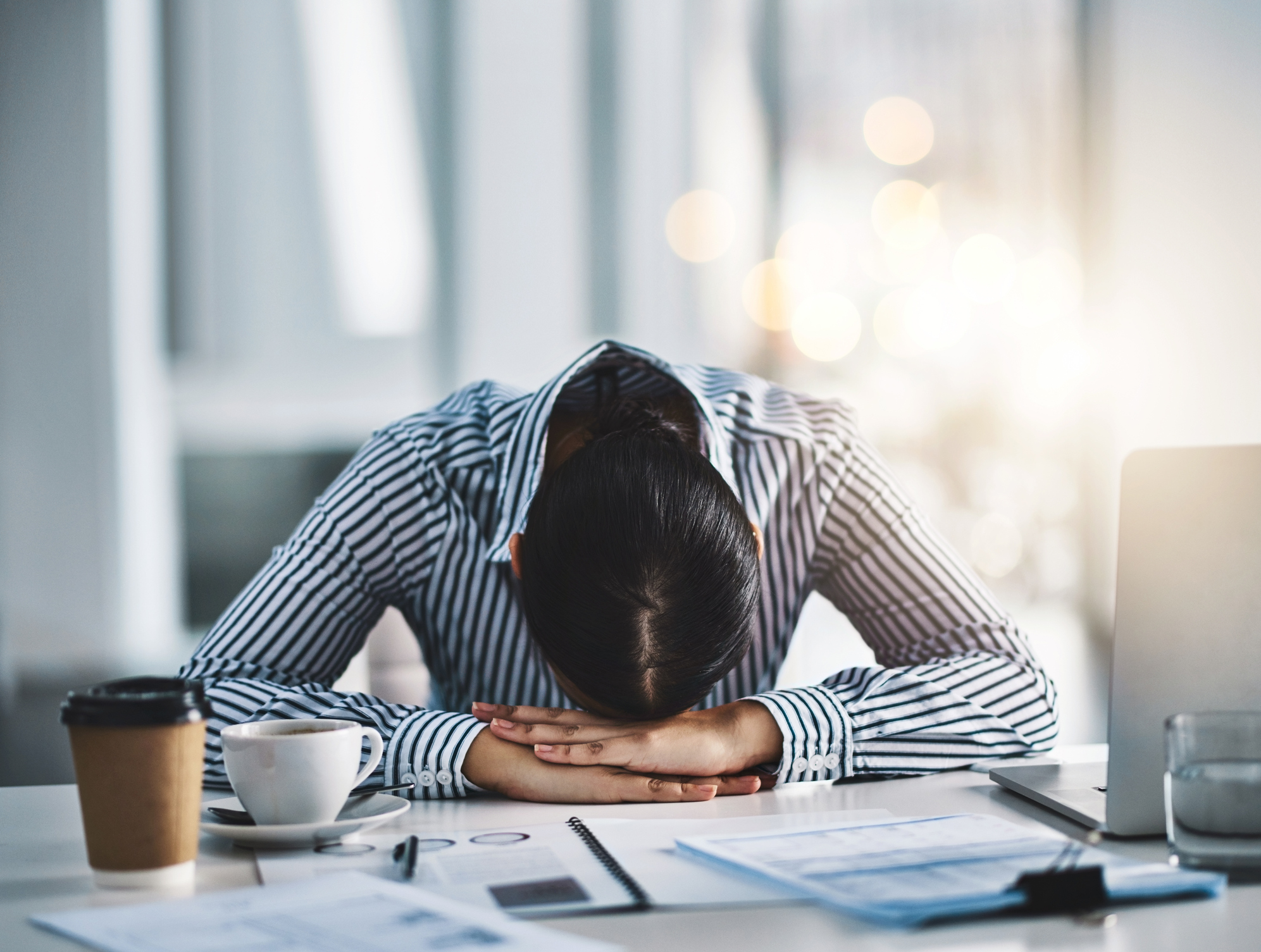 woman resting her head at work