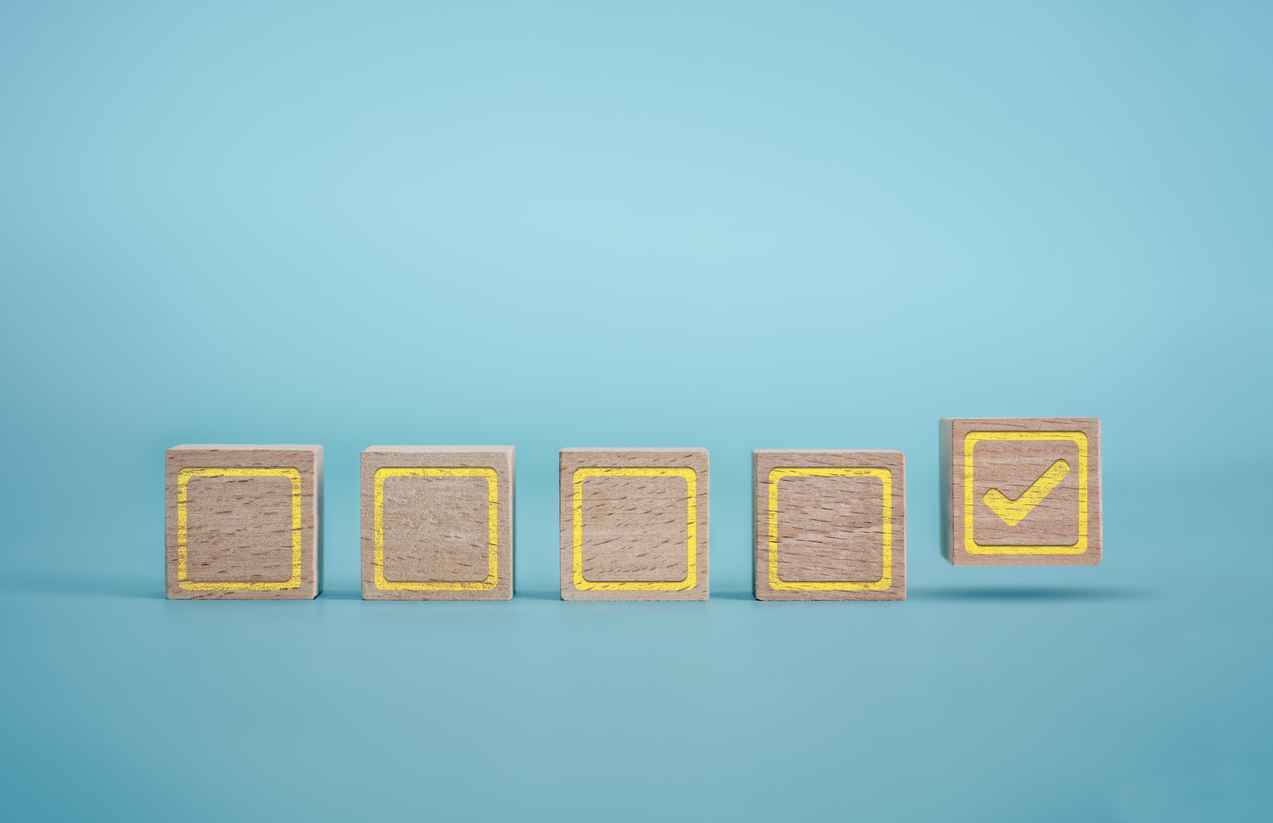 graphic of wooden blocks with yellow check marks on a blue background