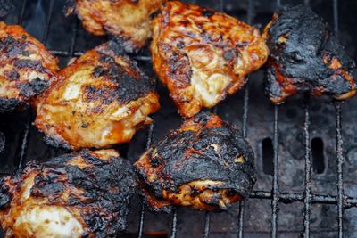 A close-up of burnt chicken on a grill 
