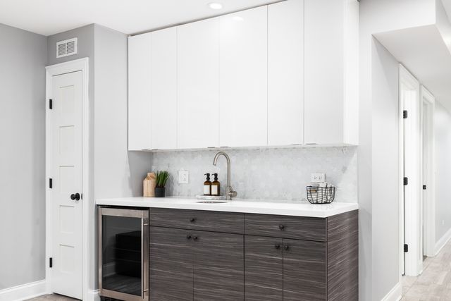 Credit:iStock Front view of a modern wet bar with a built in fridge and sink