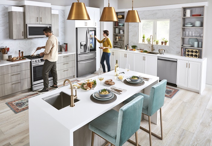couple in their modern white and grey kitchen outfitted with LG home appliances