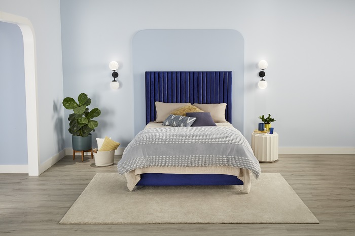 neutral blue bedroom with a Serta mattress on a made bed