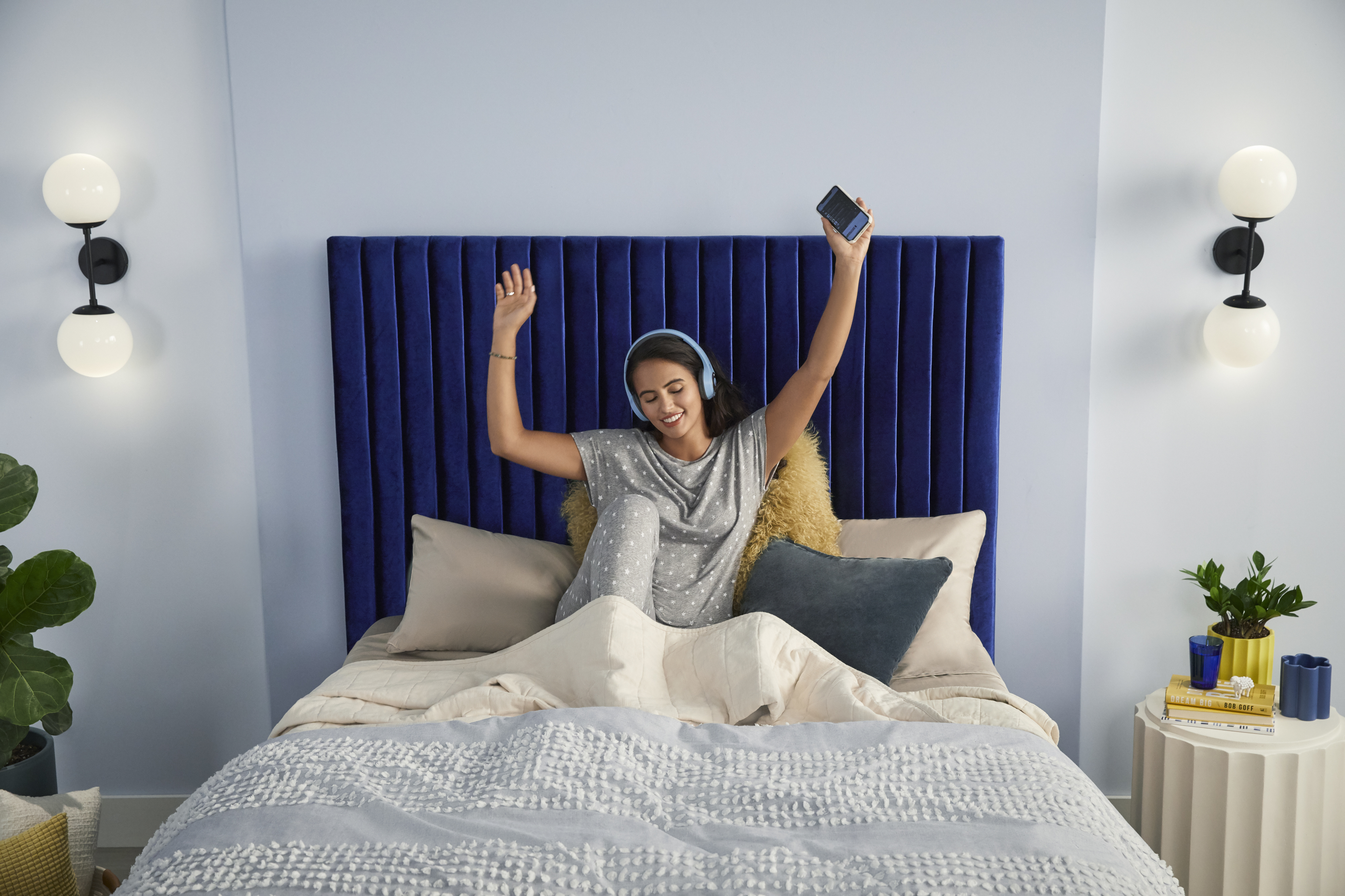 neutral blue bedroom with a Serta mattress on a made bed