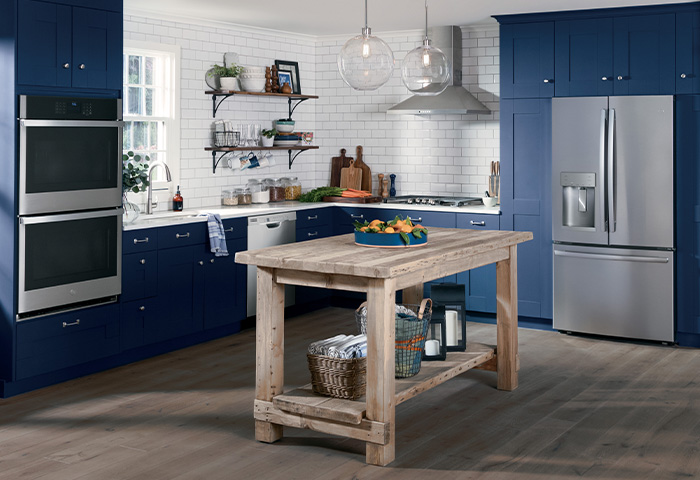 modern blue and white kitchen with GE kitchen appliance package in stainless steel finish