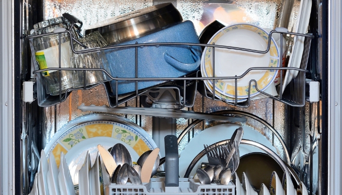 Closeup of an overloaded dishwasher