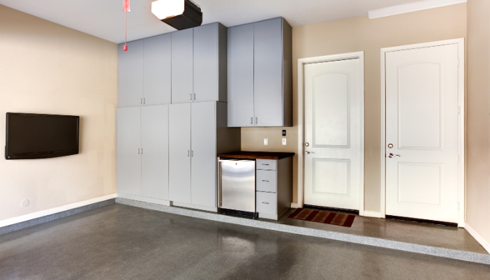 A nicely designed garage with a beverage center under some cabinets