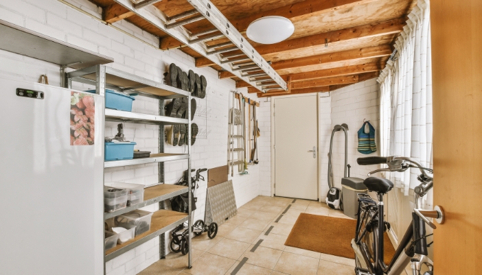 Closeup of an upright freezer in a garage/utility room