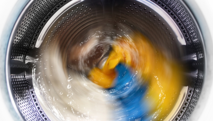 Blurred photo of a washer running a load of clothes