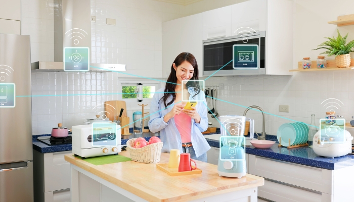 Woman using her phone to operate smart appliances seamlessly