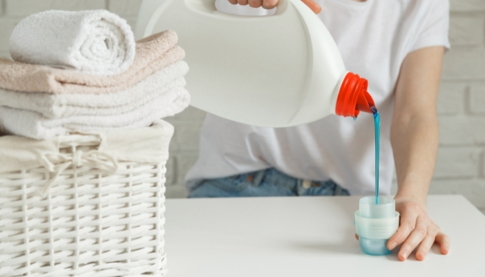 Serv_Detergent-Effects_1.jpg Closeup of someone pouring liquid detergent into cap