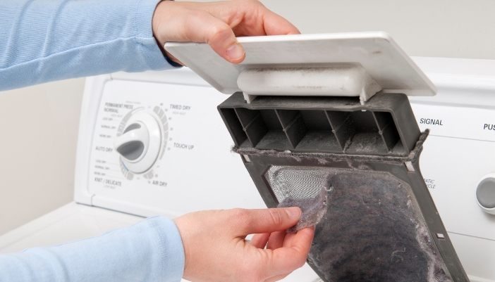 Closeup of someone cleaning the lint filter
