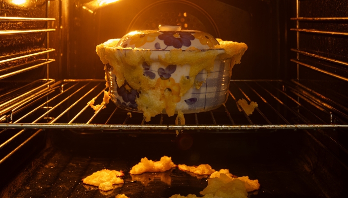 A pot that has overcooked and spilled all over the oven