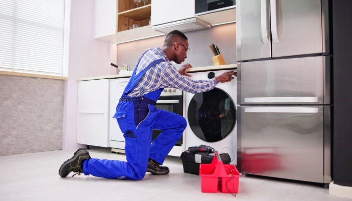 A service tech fixing a smart all-in-one washer