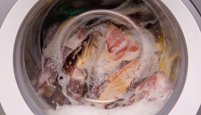 Closeup of a washer cycle and a lot of suds