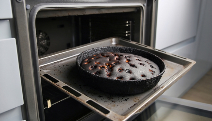 Overdone and burnt pie coming out of the oven