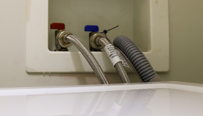 Closeup of the water valves connected to the washer