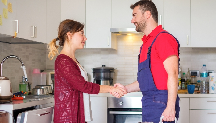Woman thanking service technician
