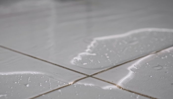 Large puddle of water on the floor from a leaking freezer