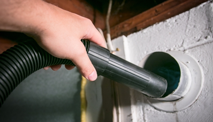 Serv_Dryer-Maintenance-Matters_2.jpg Closeup of someone vacuuming the dryer vent