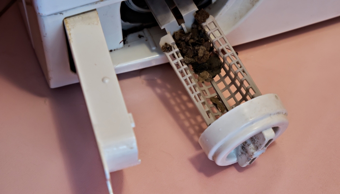 Closeup of a dirty drain pump filter