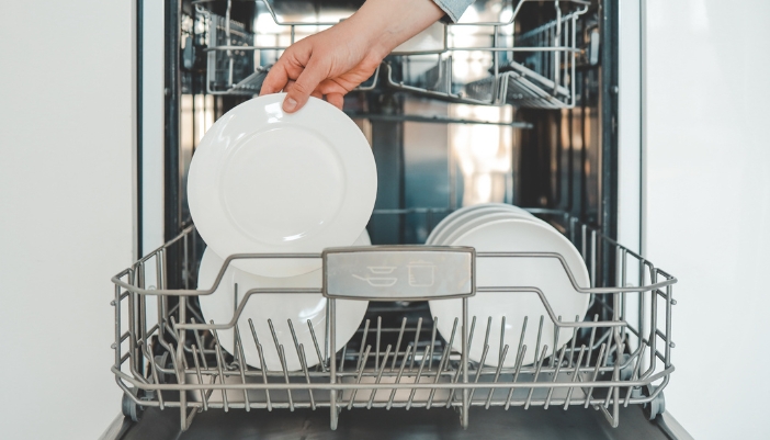 Closeup of someone deep cleaning the dishwasher