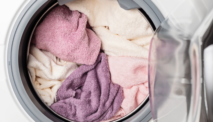 Serv_Prevent-Washing-Machine-Floods_4.jpg Closeup of a full washer loaded with thick towels