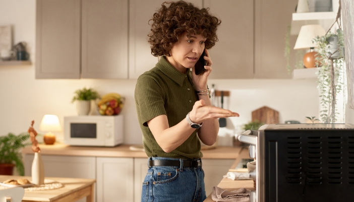 A concept image of a woman calling a service repair team for her microwave