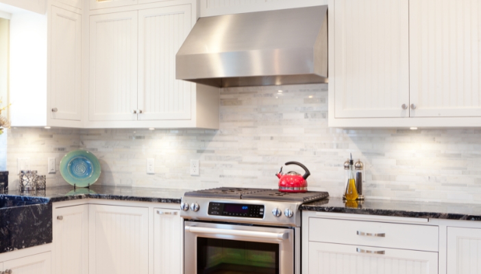 An older model of a range hood in a kitchen
