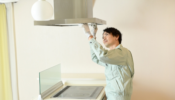 Appliance tech repairing range hood