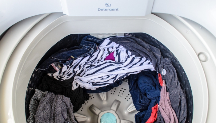 An open top load washer filled with clothes
