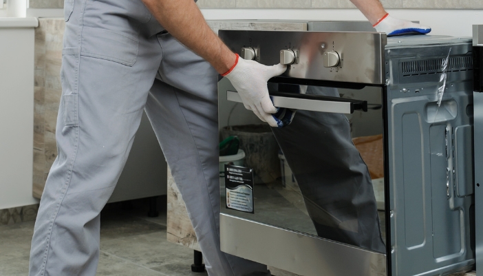 Closeup of a professional installing a wall oven