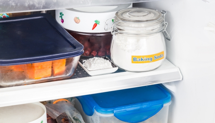 Closeup of baking soda in the fridge used to help deodorize it naturally
